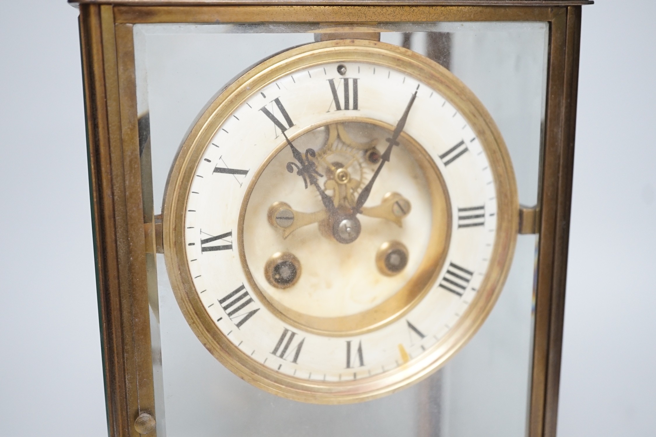 An Edwardian brass four-glass mantel clock with pendulum, presentation plaque to base, 30cm tall